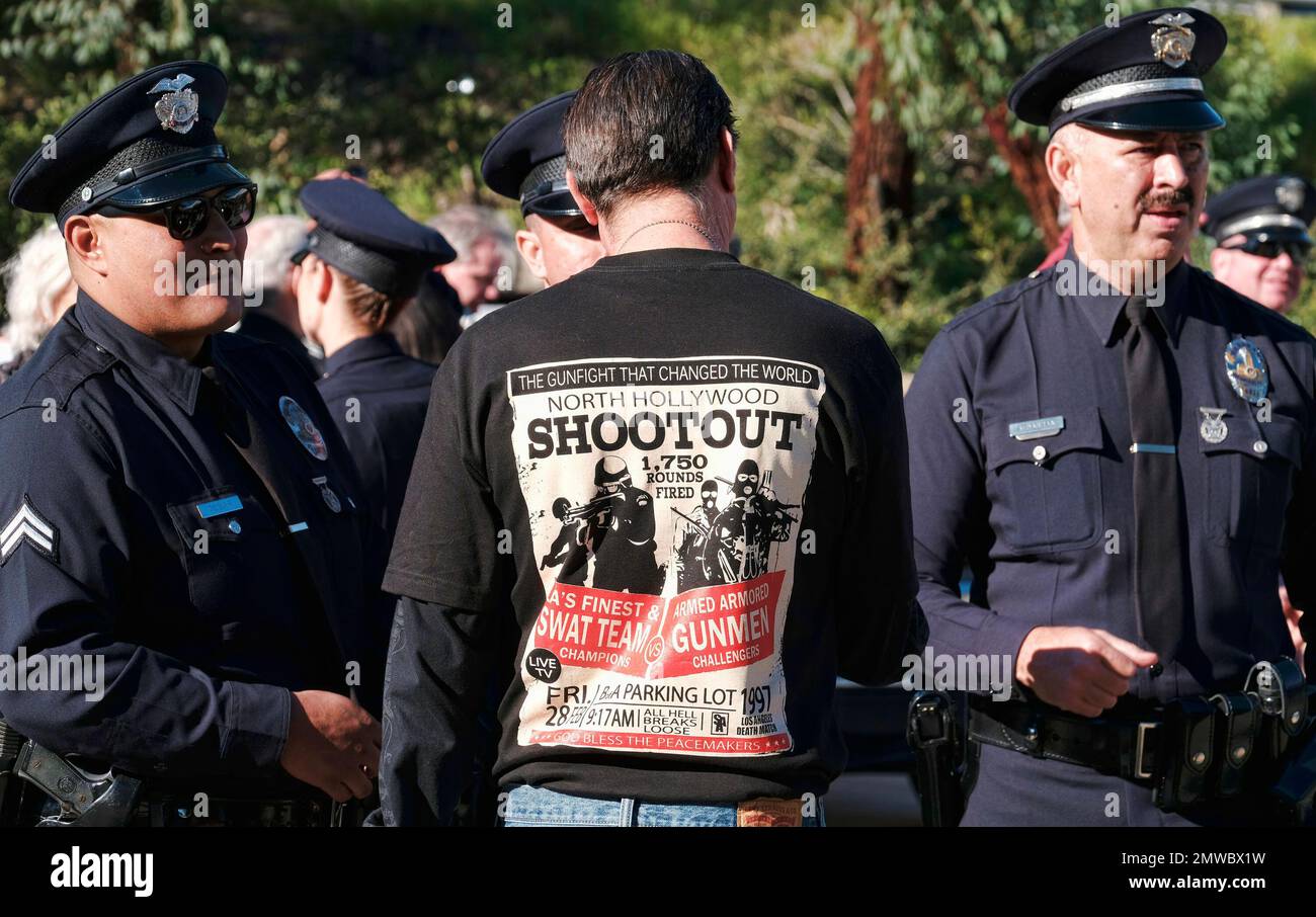 Retired Los Angeles police Sgt. Harry Rosenfeld, center, wears a Tshirt depicting the North