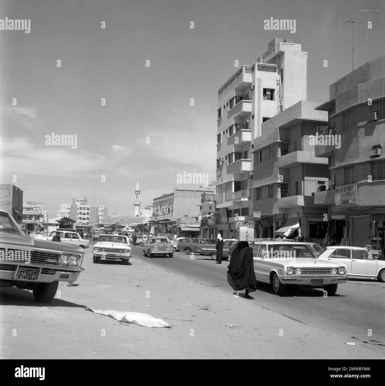 Kuwaitis in flowing black robes and women in shrouded black are seen