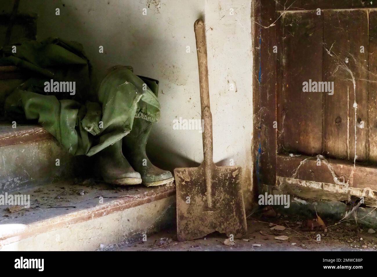 Working clothes, stairs with raincoat, rubber boots and shovel, Spain Stock Photo