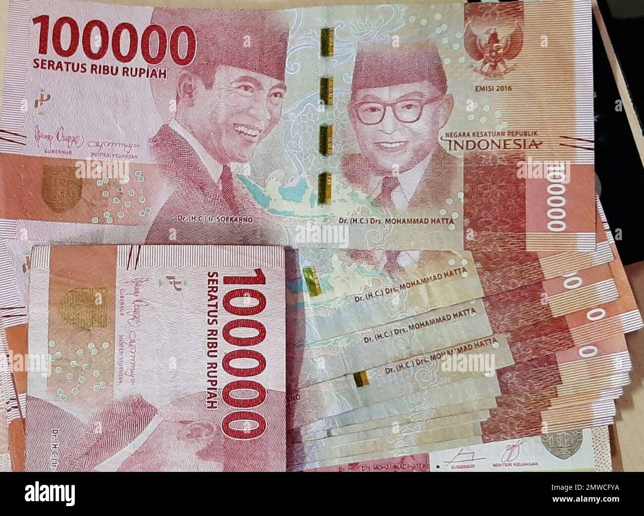 pile of 100 thousand rupiah denominations Stock Photo