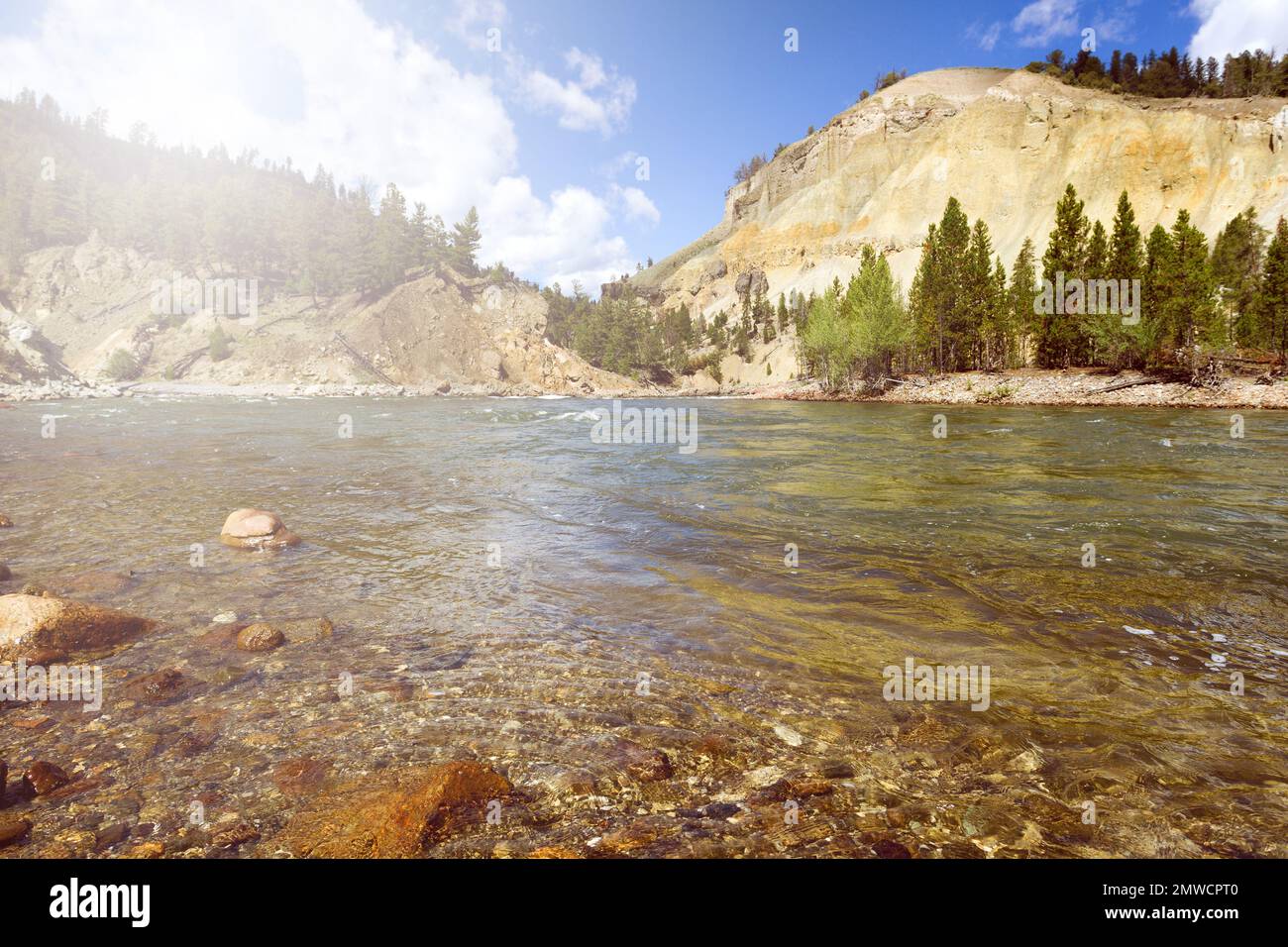 Yellowstone River running through the canyon during bright summer day. View at water level. Stock Photo