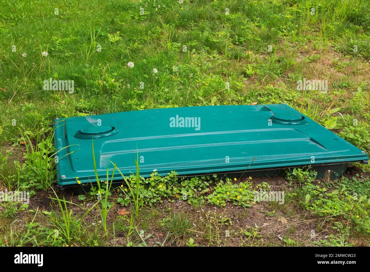 Septic tank cover in residential backyard, Quebec, Canada Stock Photo