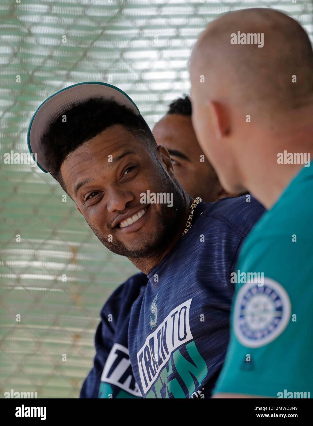 Seattle Mariners' Kyle Seager talks with staff in the dugout