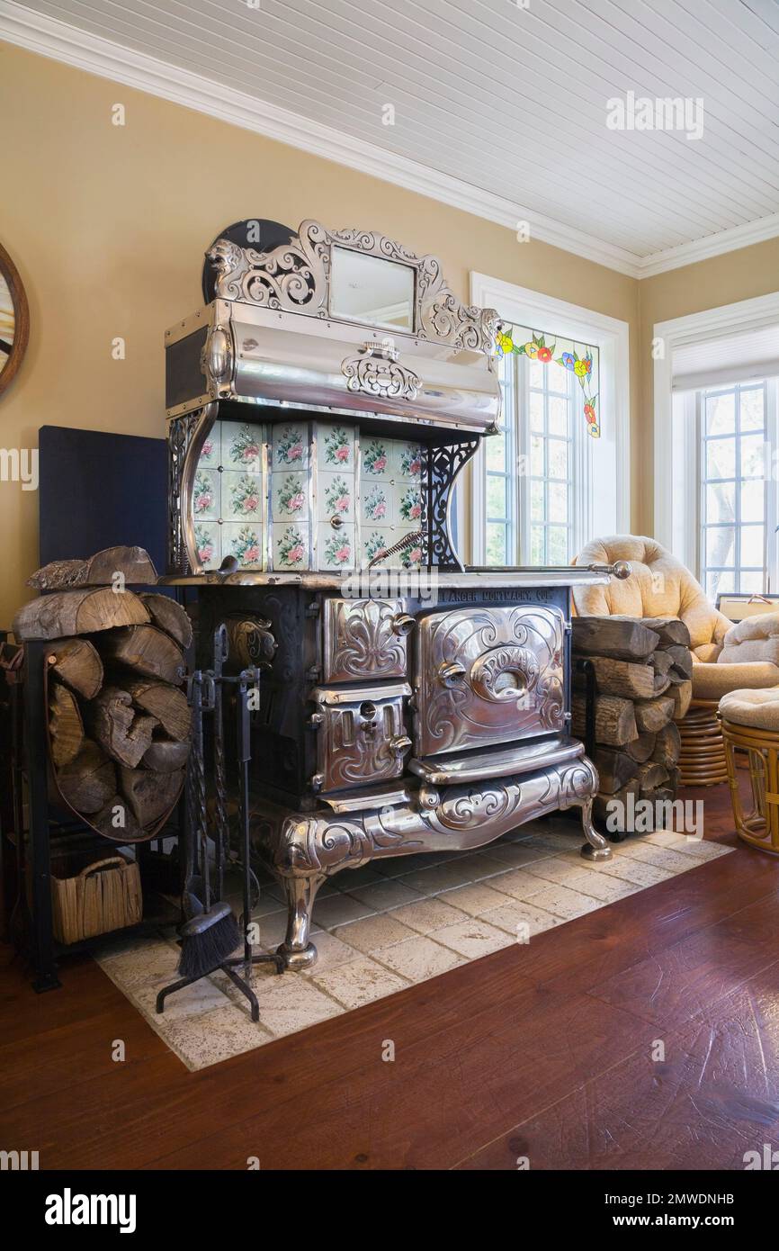Antique black cast iron and chrome Belanger Royal wood burning cook stove  in family room inside old reconstructed 1886 Canadiana cottage style home,  Q Stock Photo - Alamy