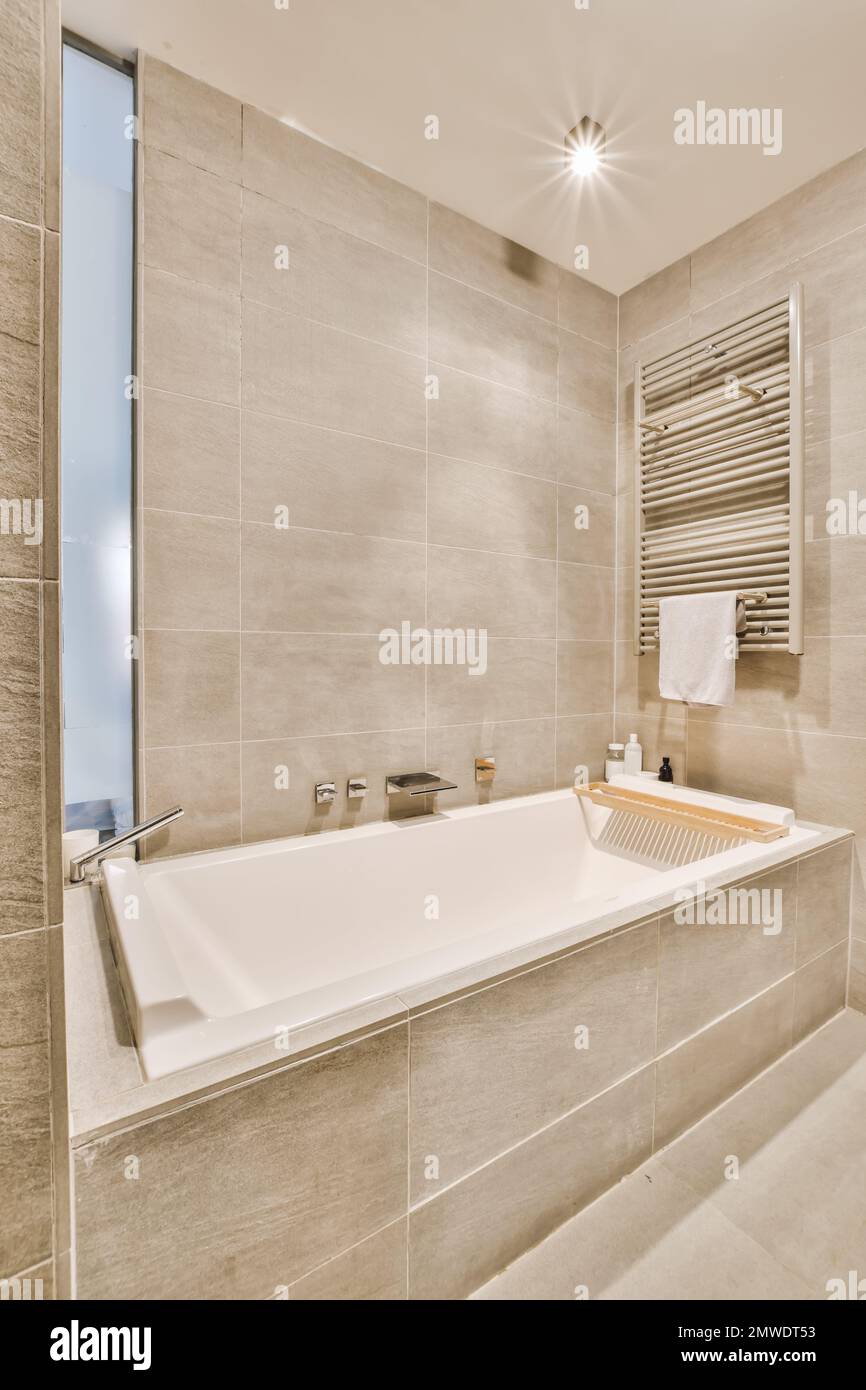 a bathroom with a bathtub and towel rack on the wall next to the