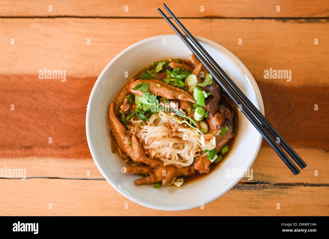 chicken noodles with chicken feet and chicken wings and vegetable on