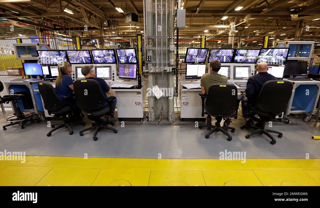 Workers monitor new automated machines assembling Boeing 737 MAX wing ...