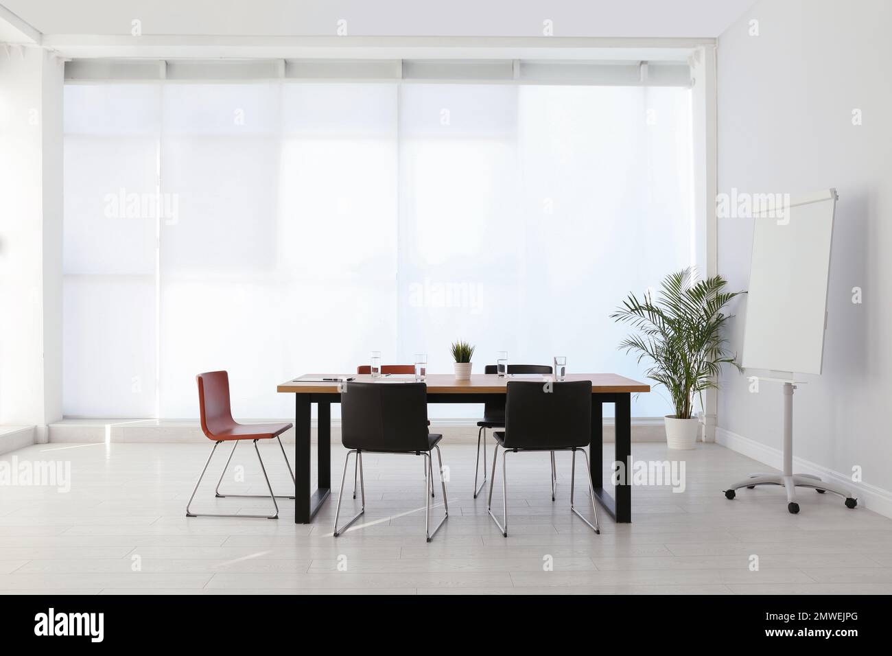 Simple office interior with large table and chairs Stock Photo - Alamy