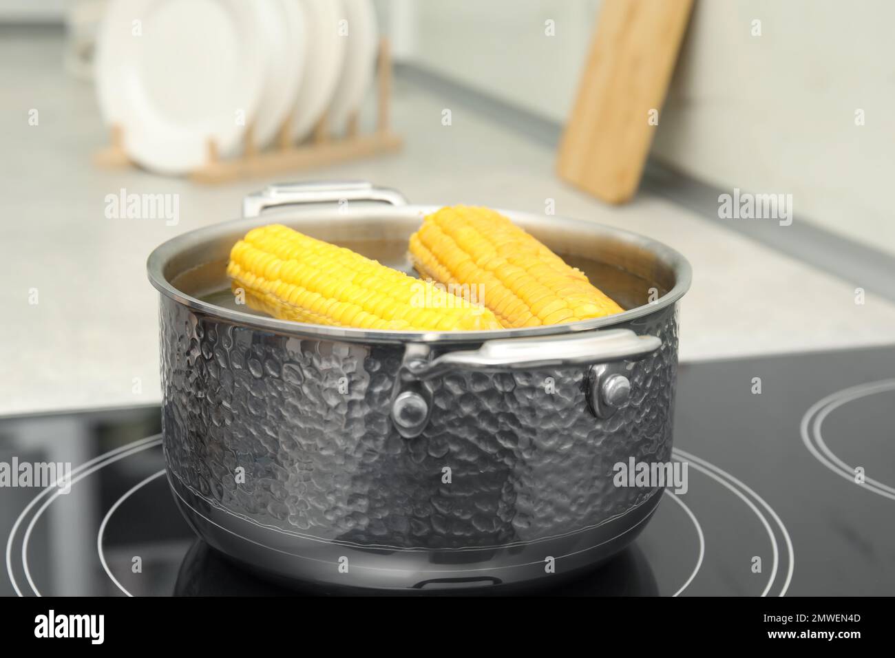 Pot with boiling corn on induction cooktop Stock Photo Alamy