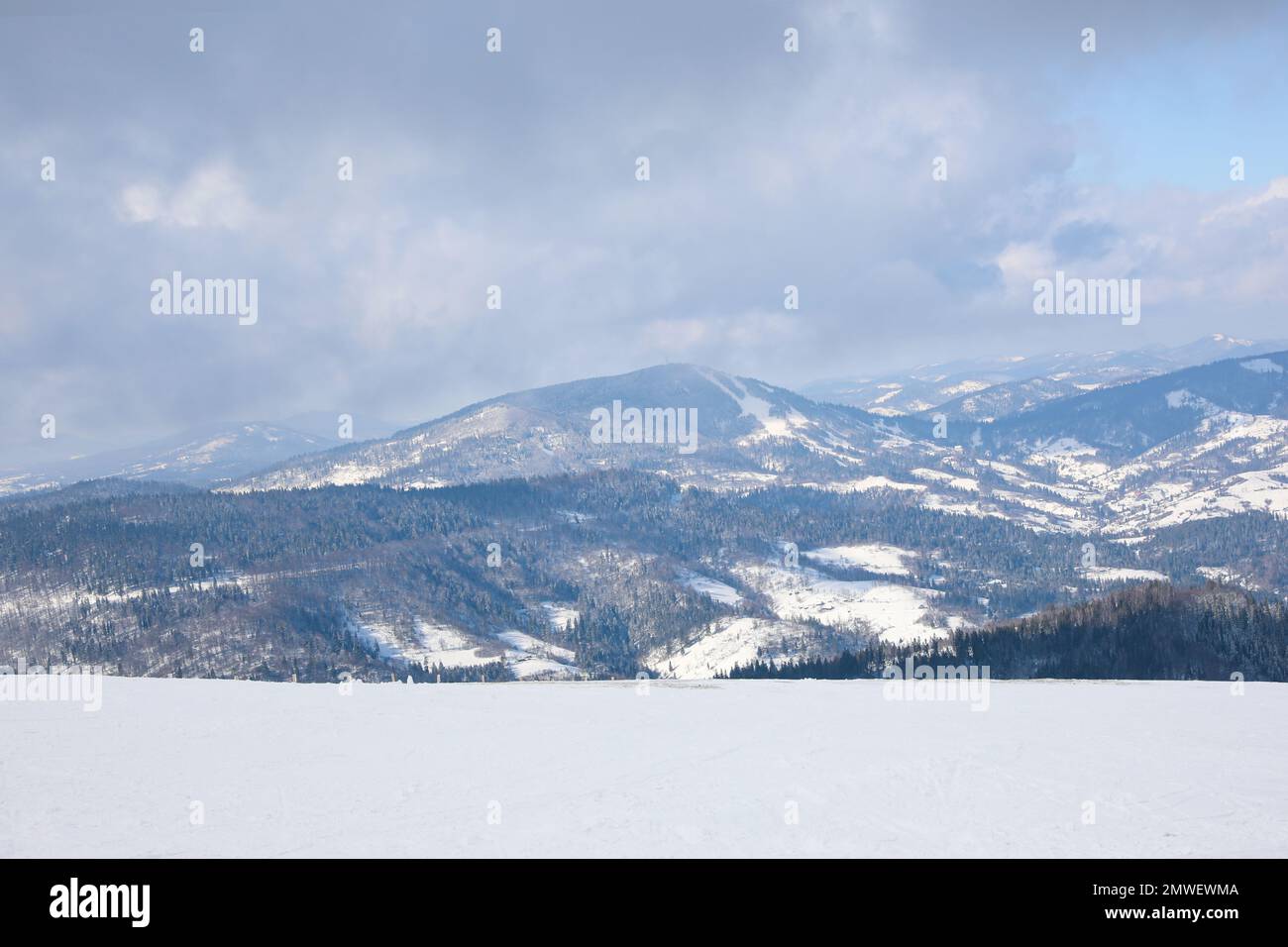 Picturesque view of snowy hills at mountain resort Stock Photo - Alamy