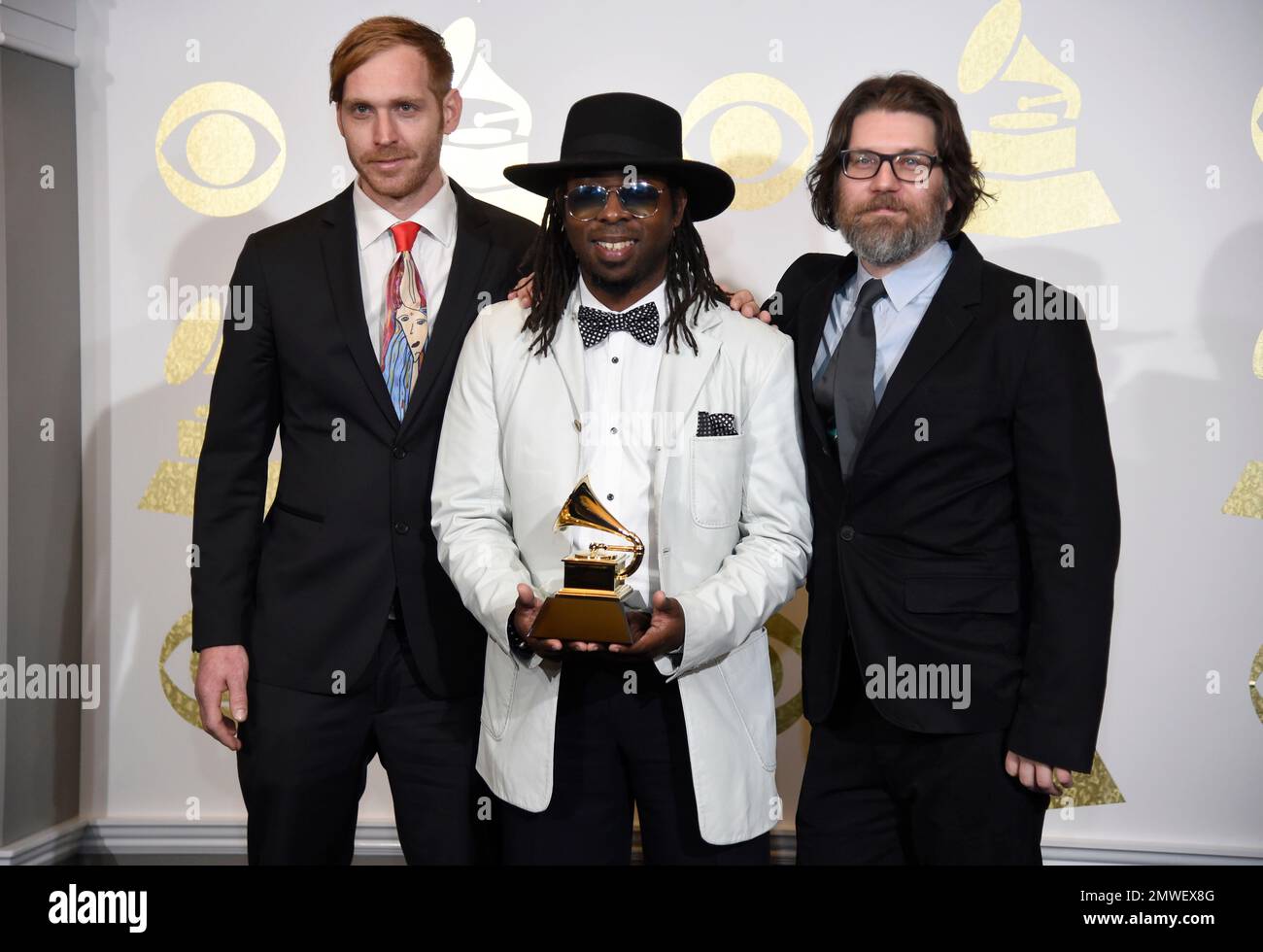 Snarky Puppy pose in the press room with with the award for best