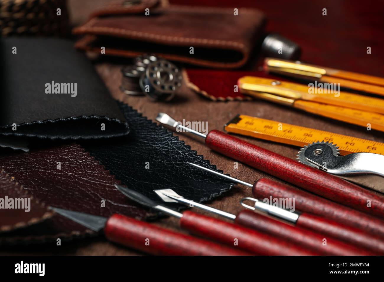 Leather samples and tools on brown table, closeup Stock Photo