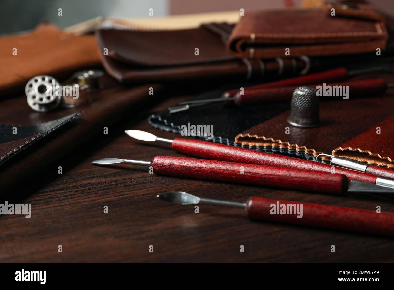 Leather samples and tools on wooden table Stock Photo