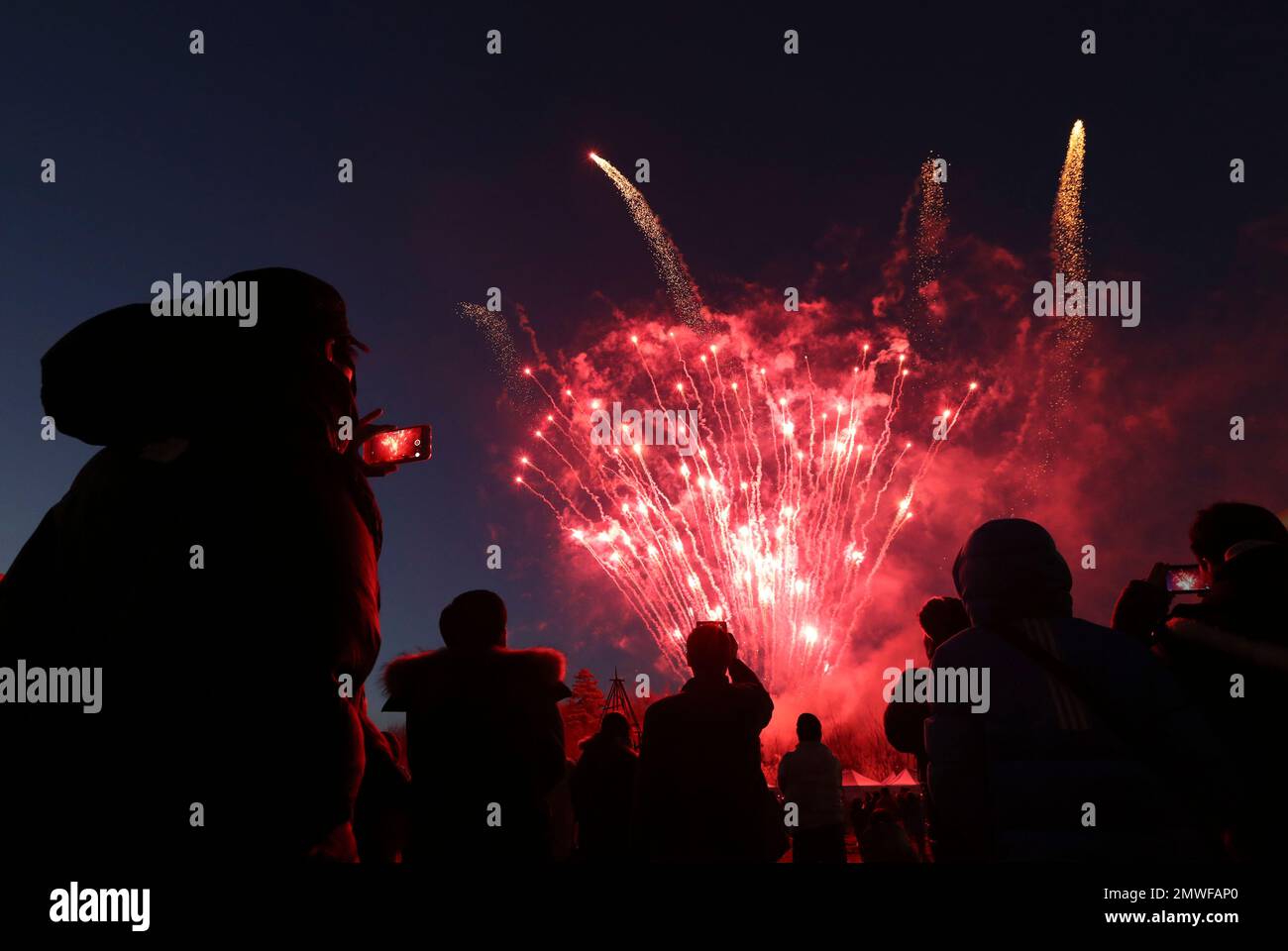 visitors-use-their-smartphones-to-take-pictures-and-to-record-fireworks