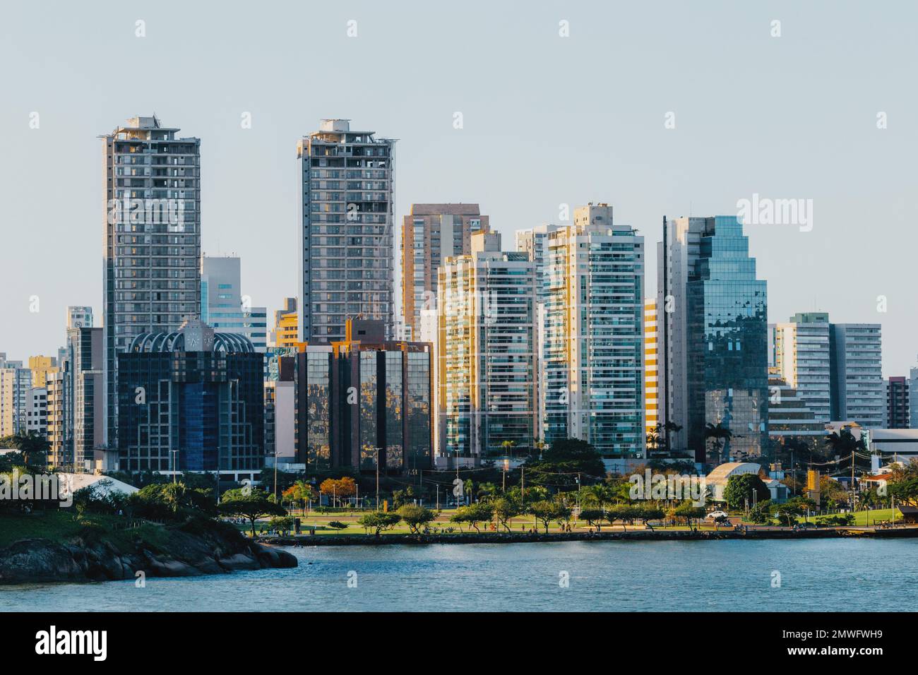 A river with modern skyscrapers in the background, Vitoria, Brazil Stock Photo