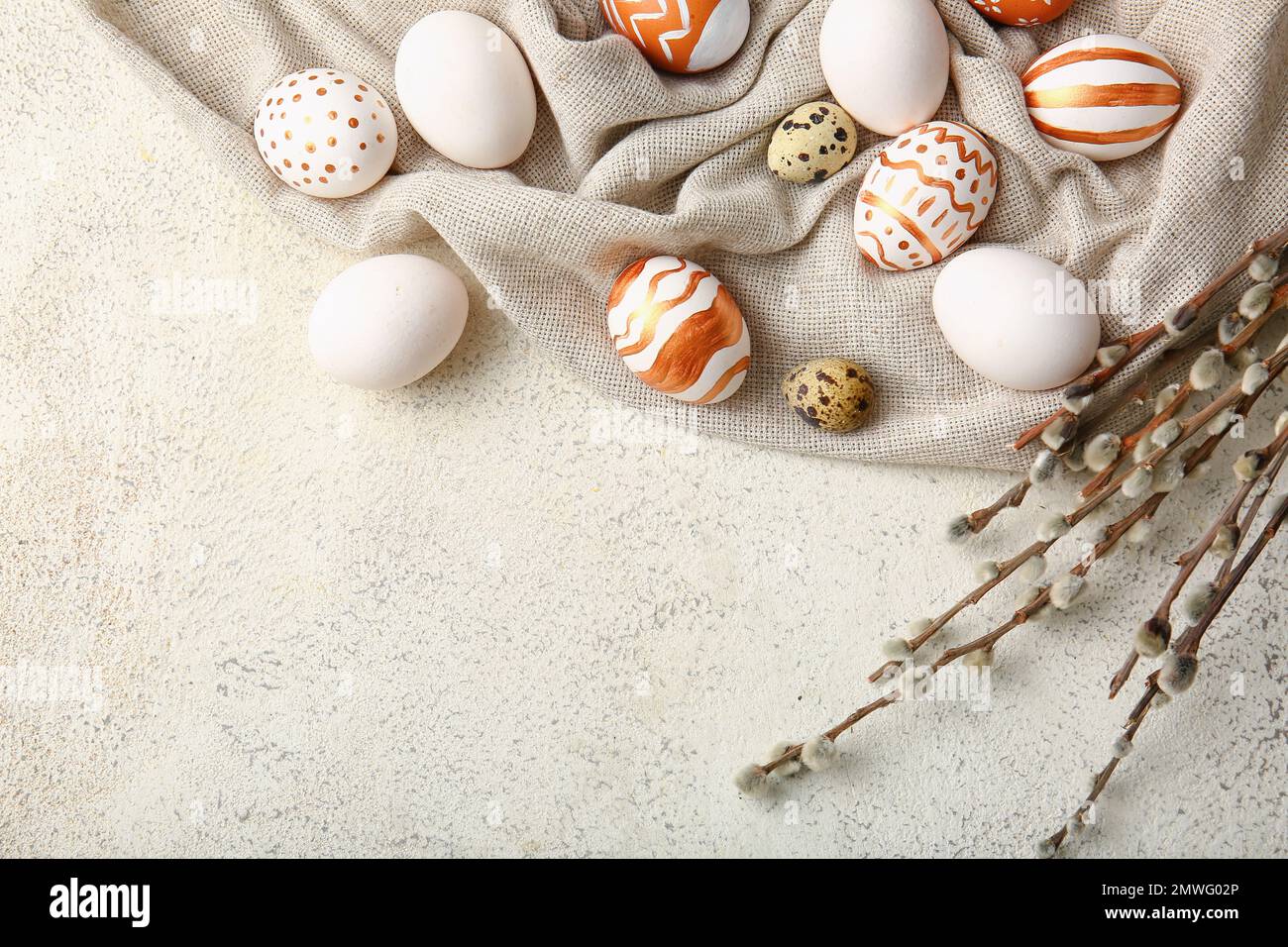 Composition with beautiful Easter eggs and willow branches on light ...