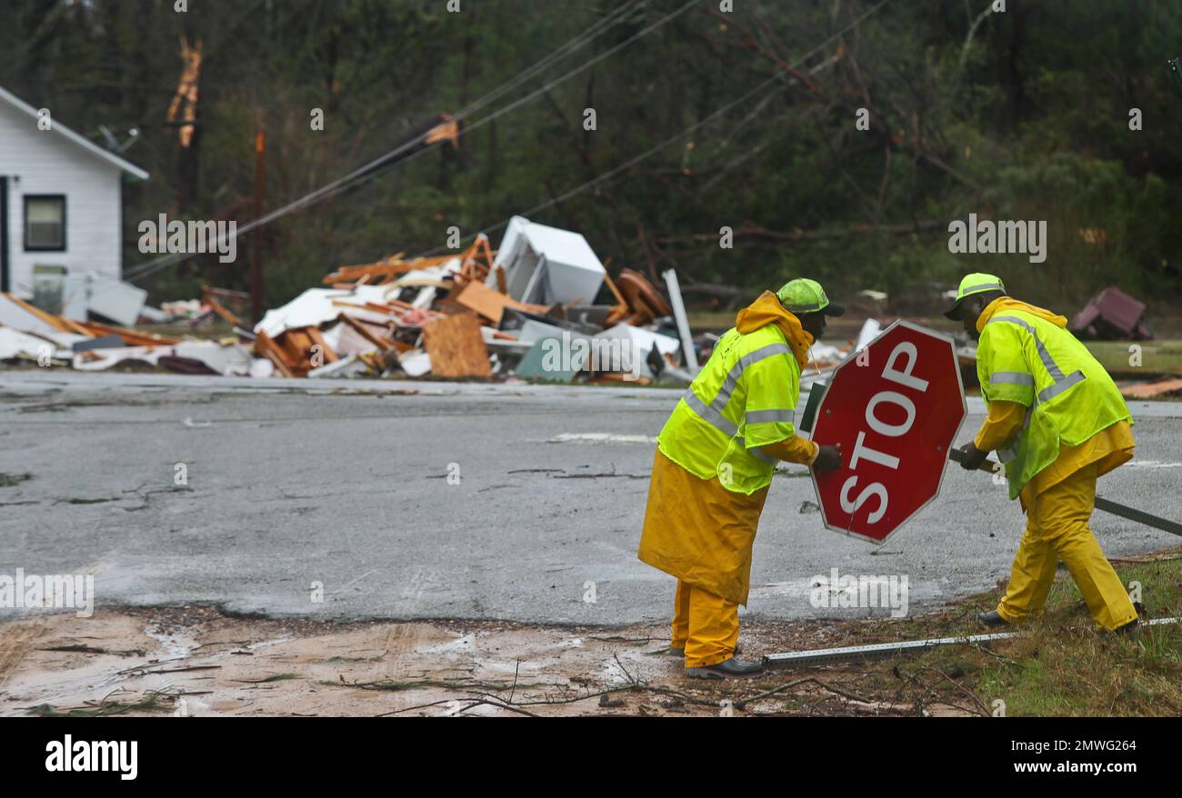 The remains of a house sit in a debris pile along Highway 122 as road