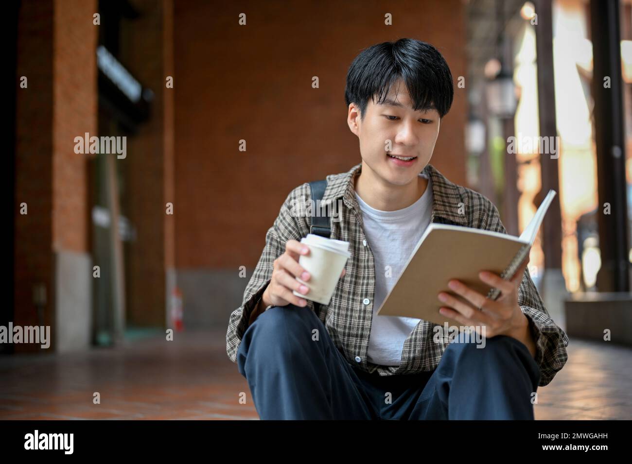 Handsome and smart young Asian male college student in casual clothes ...