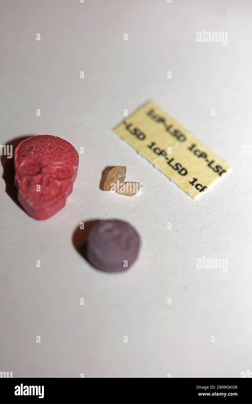 Close up on psychedelic set exstacy pills lsd papers and mdma small rocks doping background high quality big size prints Stock Photo