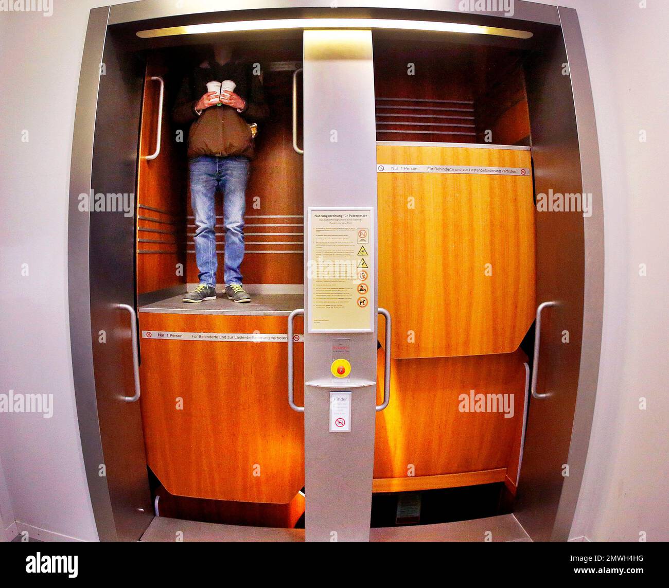 A student uses a paternoster lift in the Poelzig building at the Johann