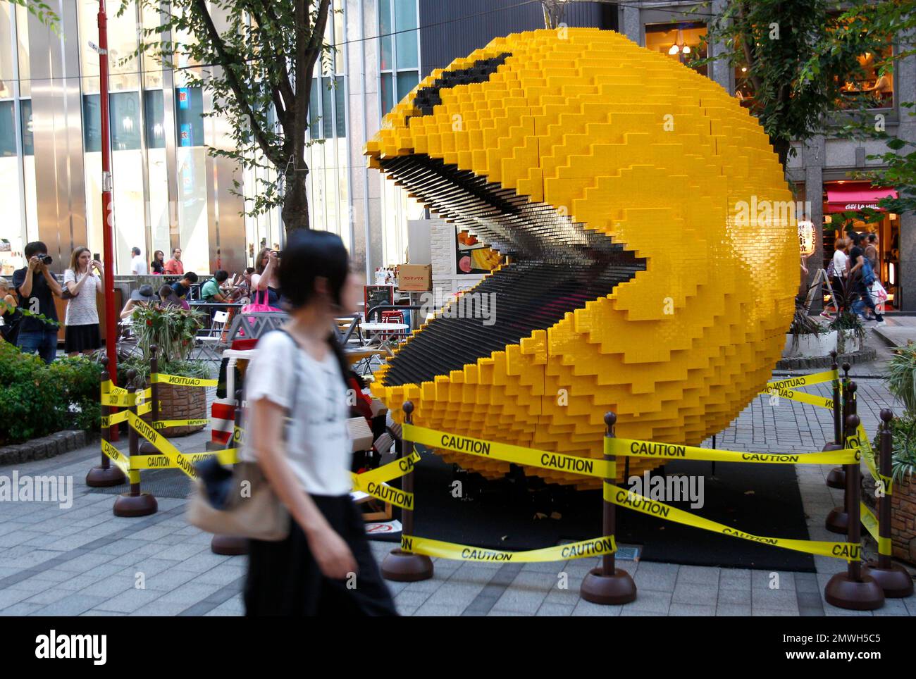 FILE - In this Aug. 12, 2015, file photo, a woman walks past a giant ...