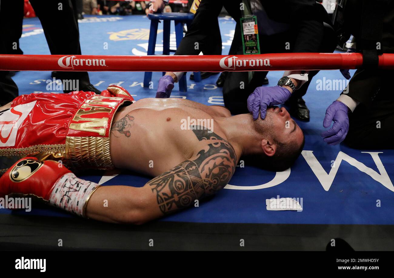 Dejan Zlaticanin, of Montenegro, lies on the mat after he was knocked