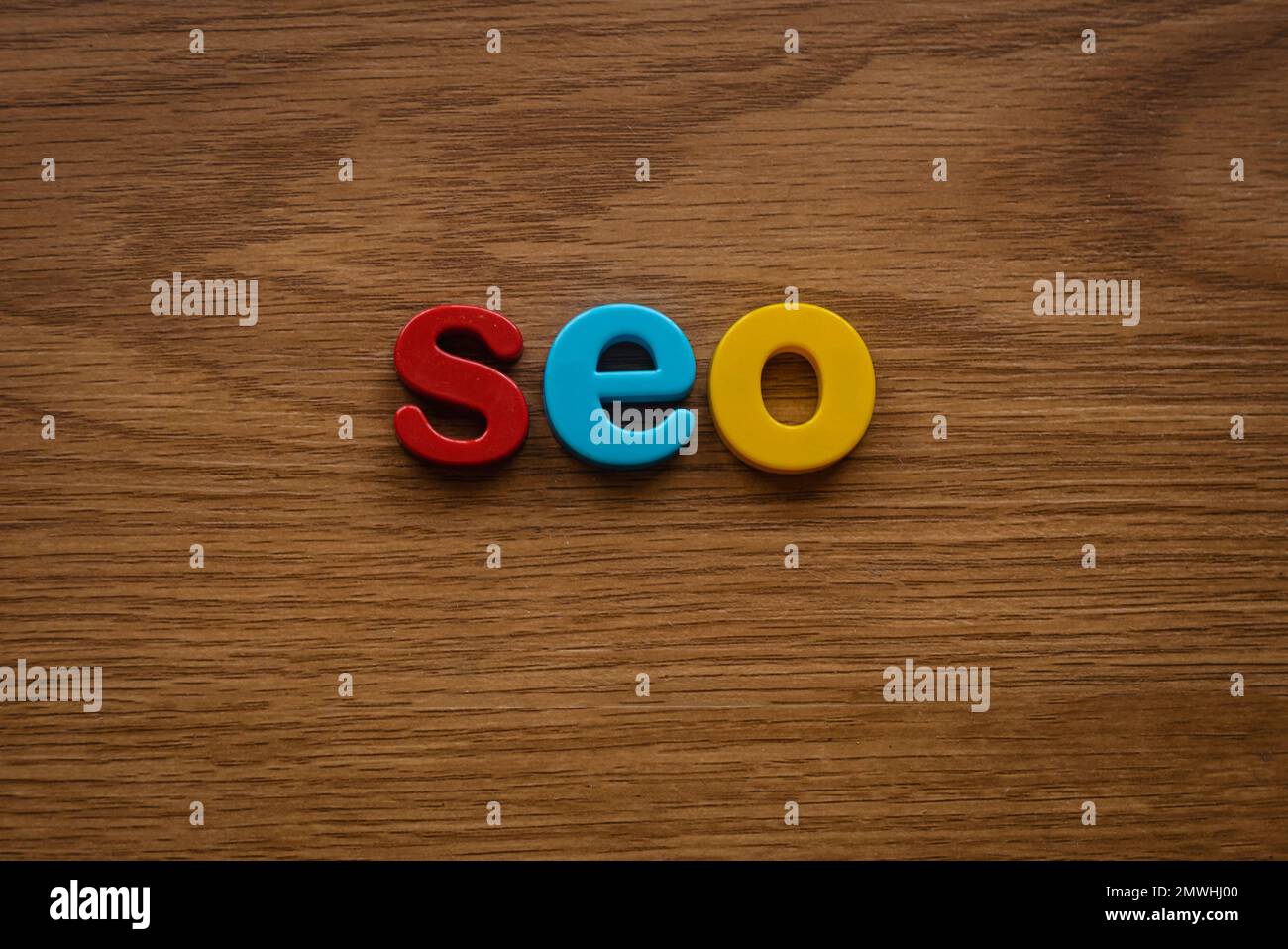 Search engine optimization concept. Alphabet of seo on a wooden background. Stock Photo
