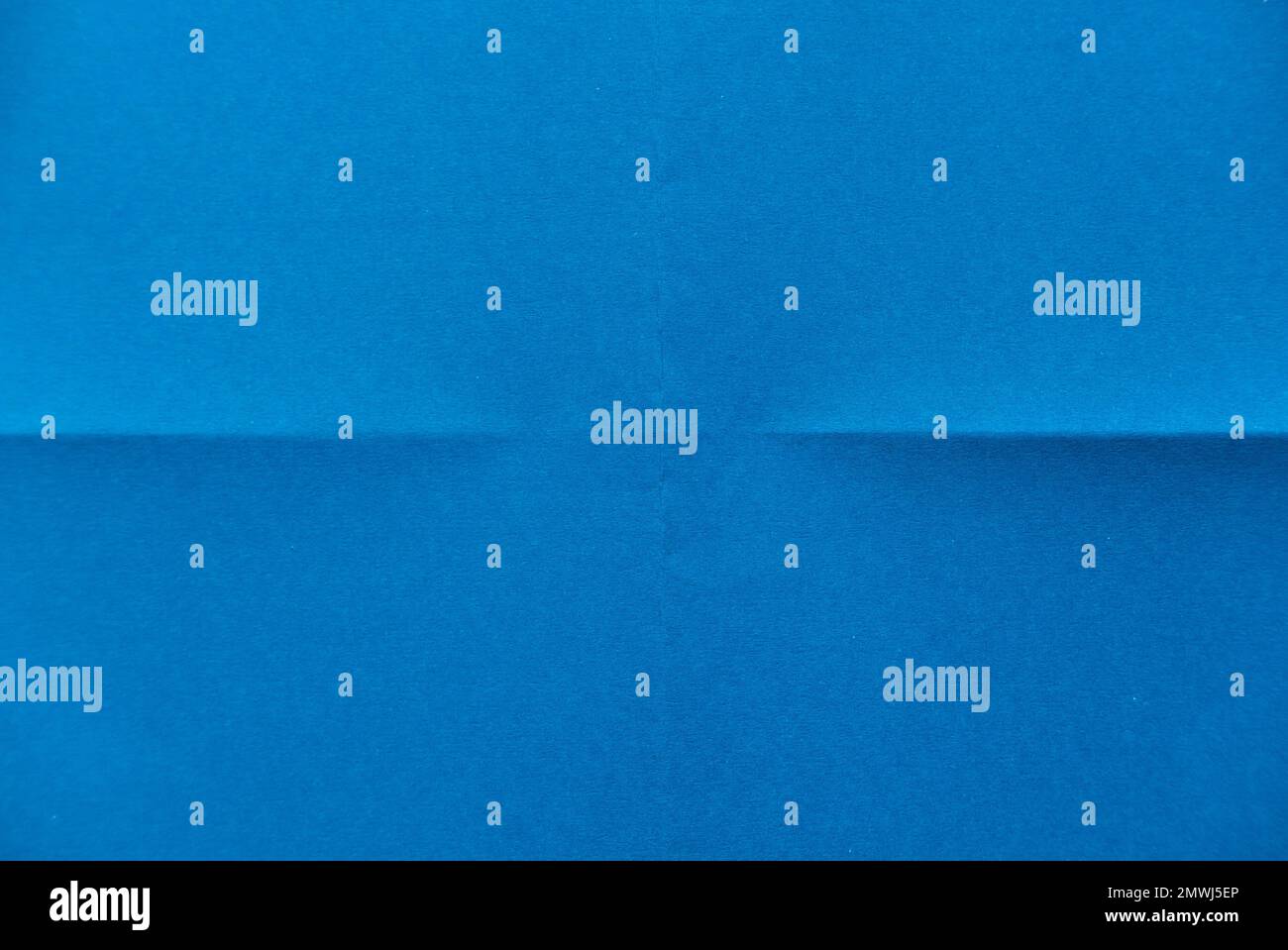 Folded blue paper for background. Stock Photo