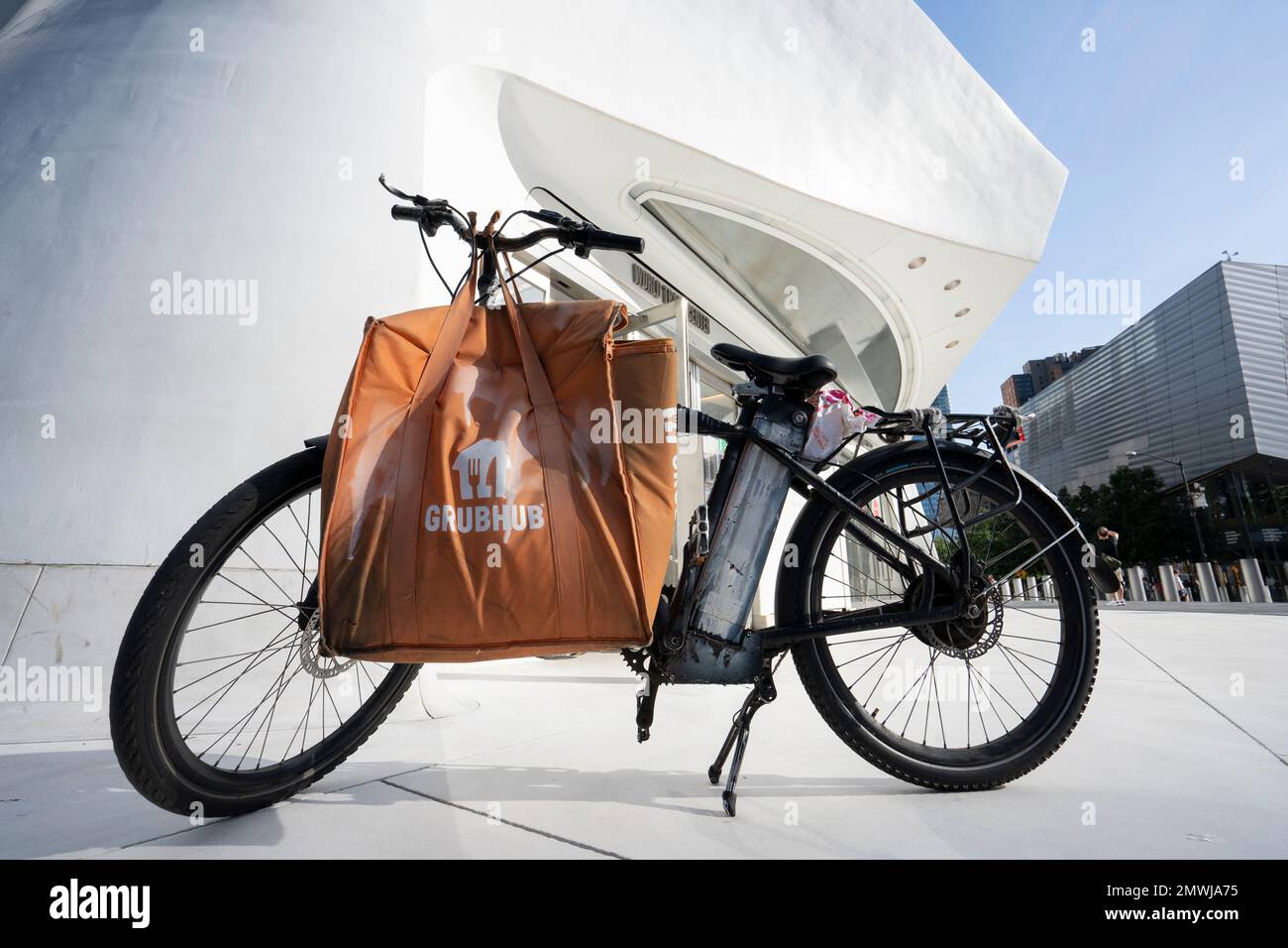 A Grubhub delivery bag is seen on a bike parked outside the entrance to the Oculus in Lower Manhattan, New York City, on Monday, July 4, 2022. Stock Photo