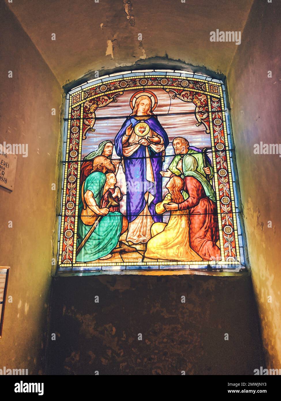 A vertical shot of a stained glass window of the Holy Trinity Catholic ...