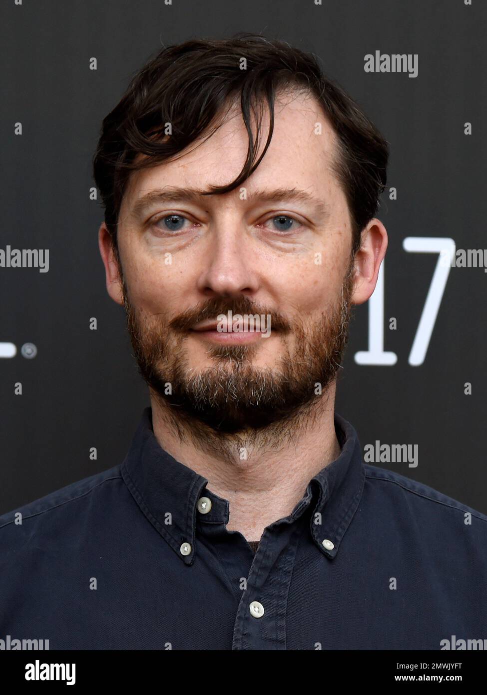 Dustin Guy Defa, writer/director of "Person to Person," poses at the