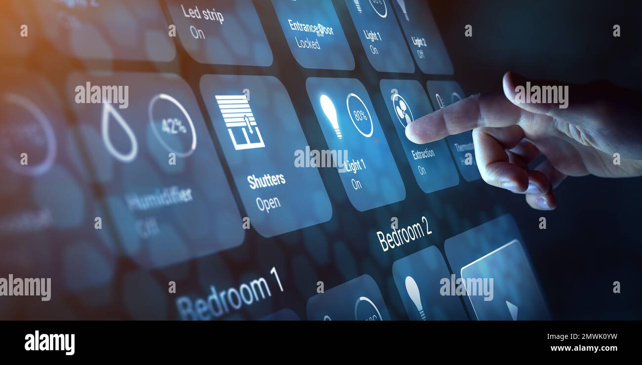 Person touching a button on smart home dashboard interface to control connected devices and set up automation technology. Using smart assistant to use Stock Photo