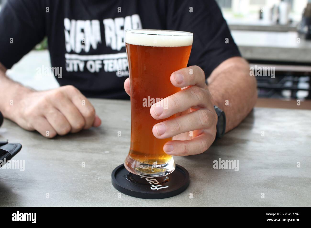 Holding a beer in a bar in Vietnam Stock Photo