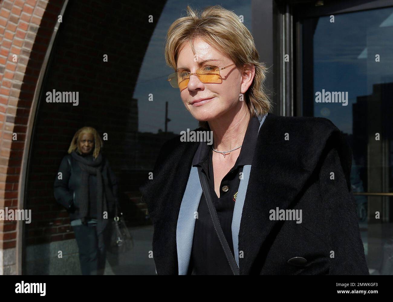 FILE - In a Thursday, Feb. 7, 2013 file photo, author Patricia Cornwell leaves federal court in Boston, after she took the stand in her lawsuit against her former financial management company. Cornwell settled a lawsuit Tuesday, Jan. 17, 2017, against her former business managers, avoiding a second trial for a case that dates to 2009. The author had claimed the New York accounting firm Anchin, Block & Anchin LLP was negligent in handling her finances and cost her millions in losses or unaccounted for revenue. (AP Photo/Steven Senne, File) Stock Photo