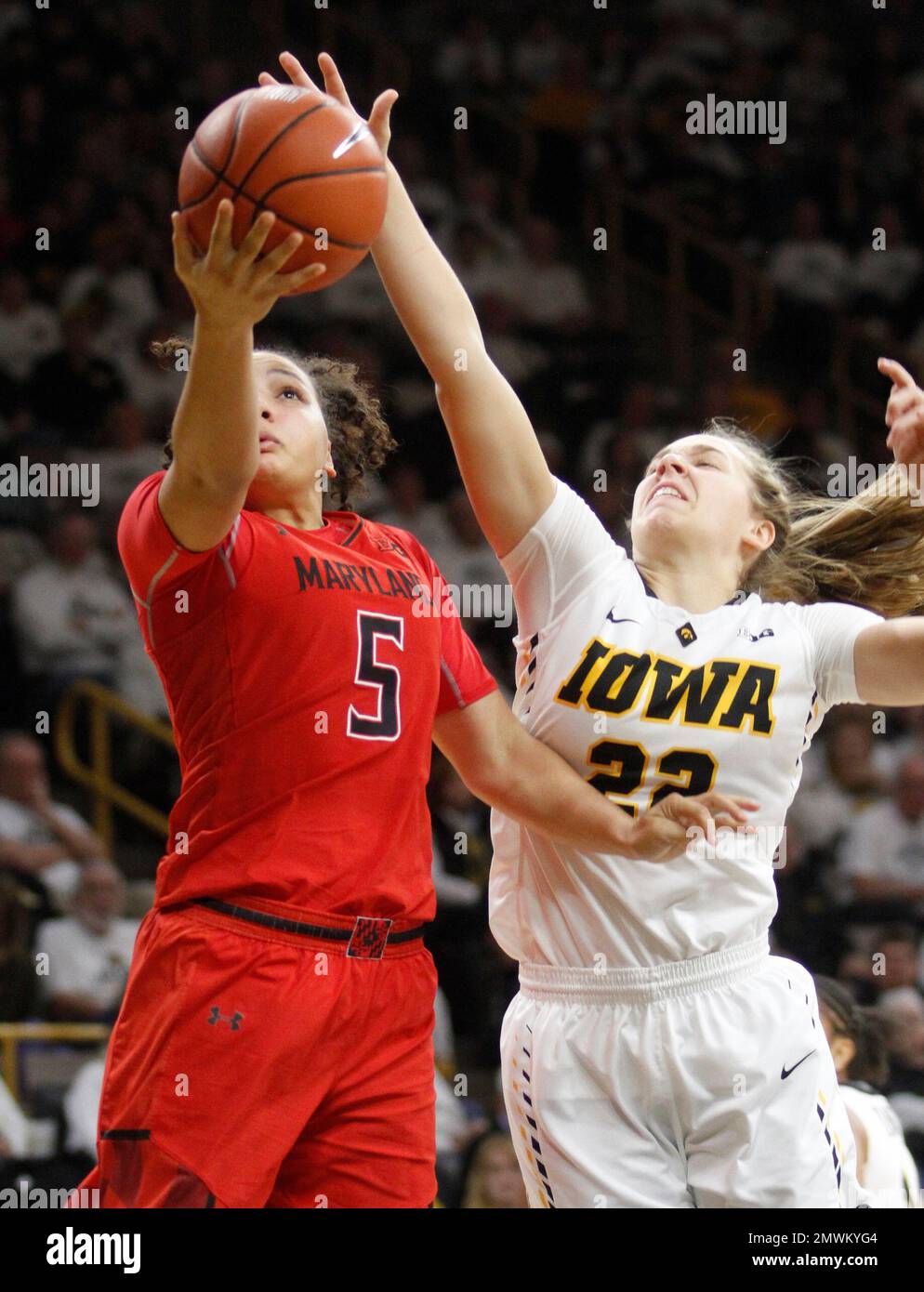 Maryland's Destiny Slocum (5) goes to the basket in front of Iowa's
