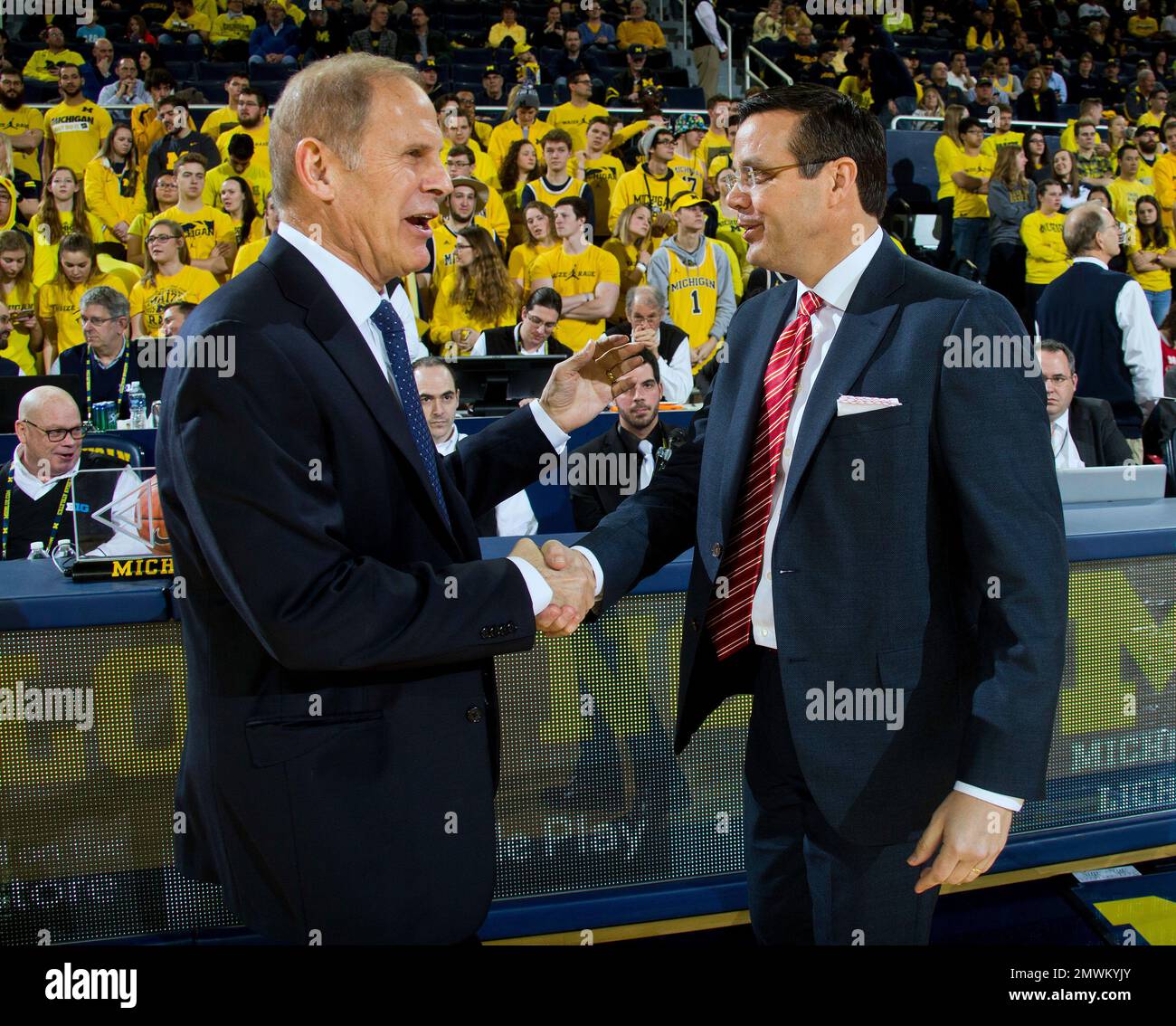 Michigan head coach John Beilein, left, shakes hands with Nebraska head ...