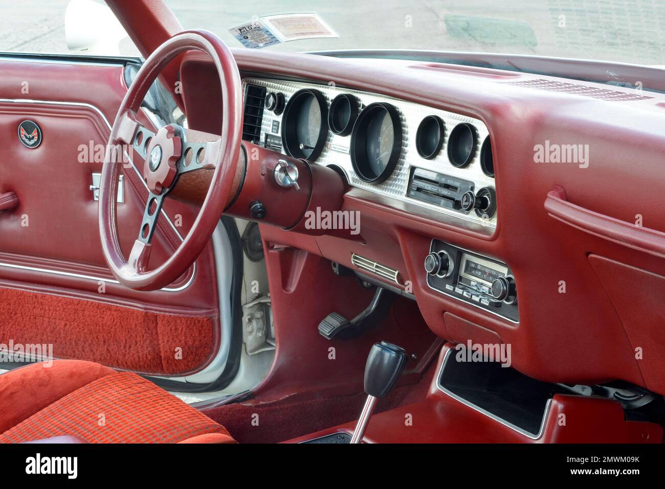 Dashboard and red interior in a 1979 Pontiac Trans Am. Stock Photo