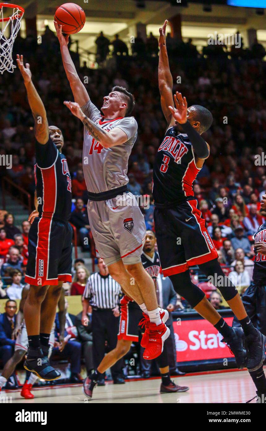 New Mexico&#039;s Dane Kuiper (14) shoots between UNLV&#039;s Christian Jones