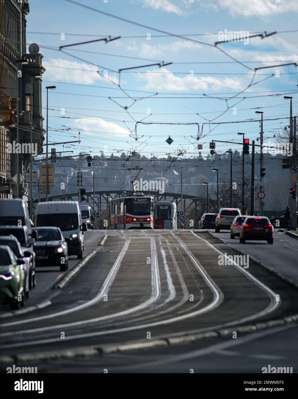 A vertical shot of trams and cars in a heavy traffic in an urban city ...