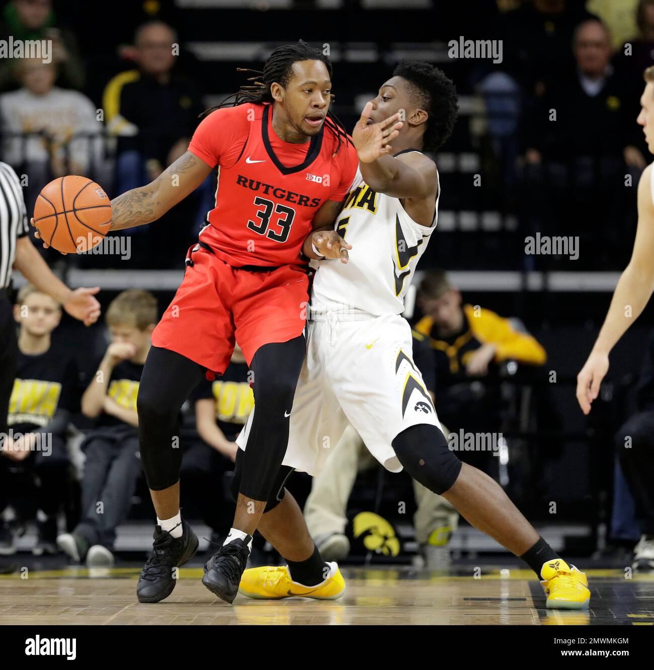 Rutgers forward Deshawn Freeman, left, drives around Iowa forward Tyler Cook during the first