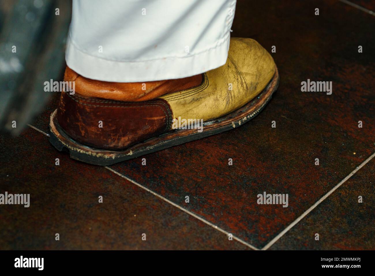 the sole of an old worn yellow shoe of a man in white pants Stock Photo ...