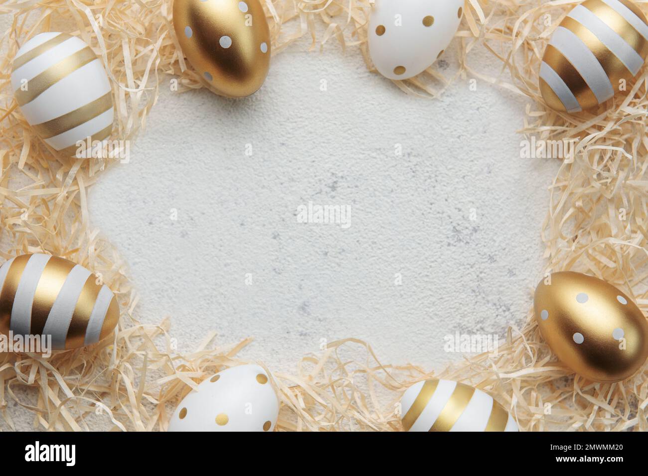 Easter eggs painted with gold paint on a straw background. Concept of ...