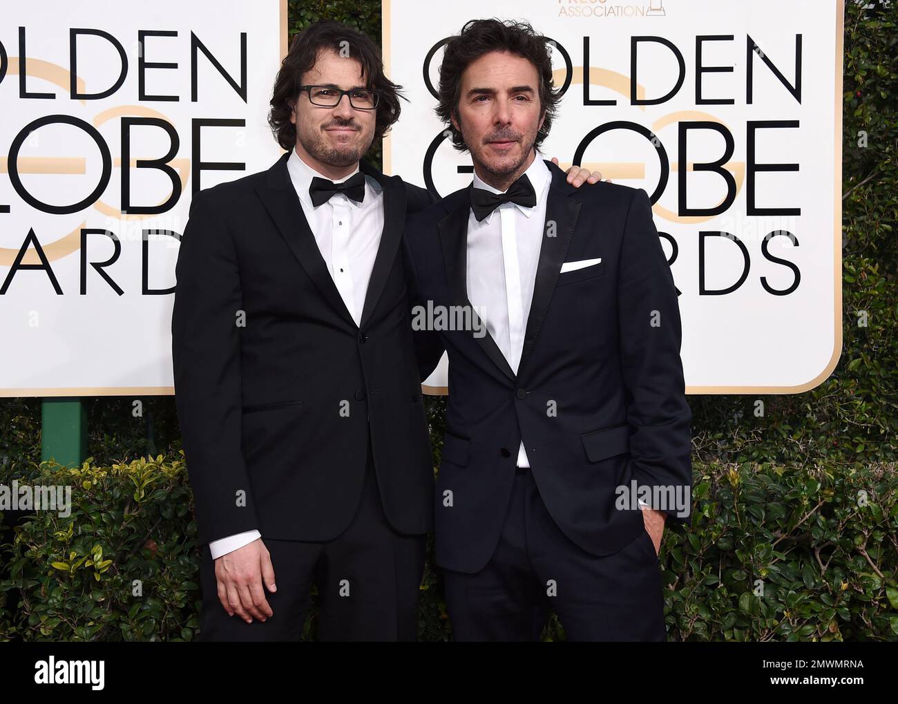 Dan Cohen, left, and Shawn Levy arrive at the 74th annual Golden Globe