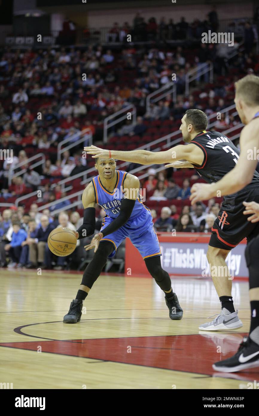 The Oklahoma City Thunder's Russell Westbrook passes under Houston