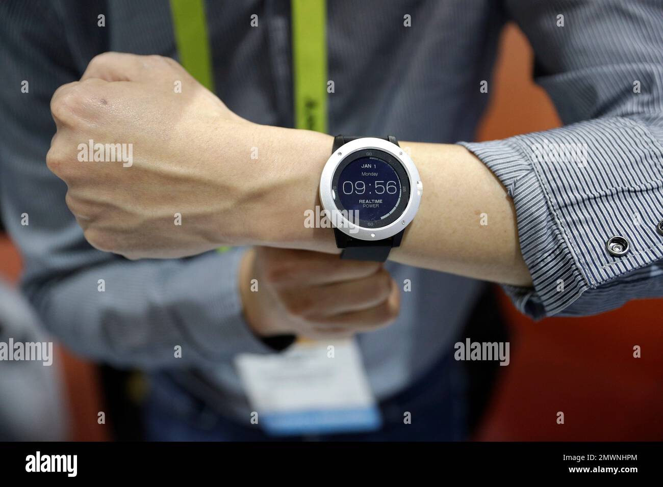 An employee demonstrates the Matrix Powerwatch during CES Unveiled ...