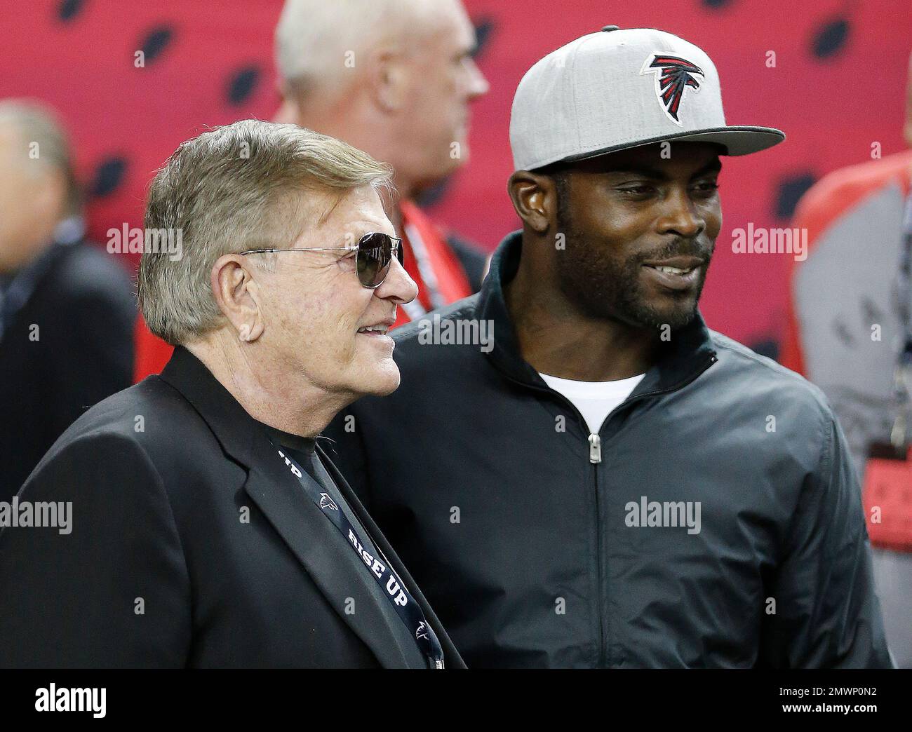 Former Atlanta Falcons Head Coach Jerry Glanville, left, stands with former Atlanta  Falcons quarterback Michael Vick on the turf before the first half of an  NFL football game between the Atlanta Falcons