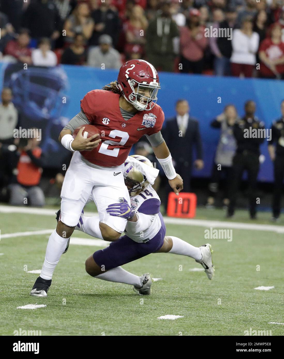 Alabama quarterback Jalen Hurts (2) is sacked by Washington defensive