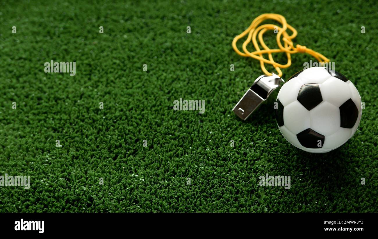 Soccer ball and a whistle on a football field Stock Photo Alamy