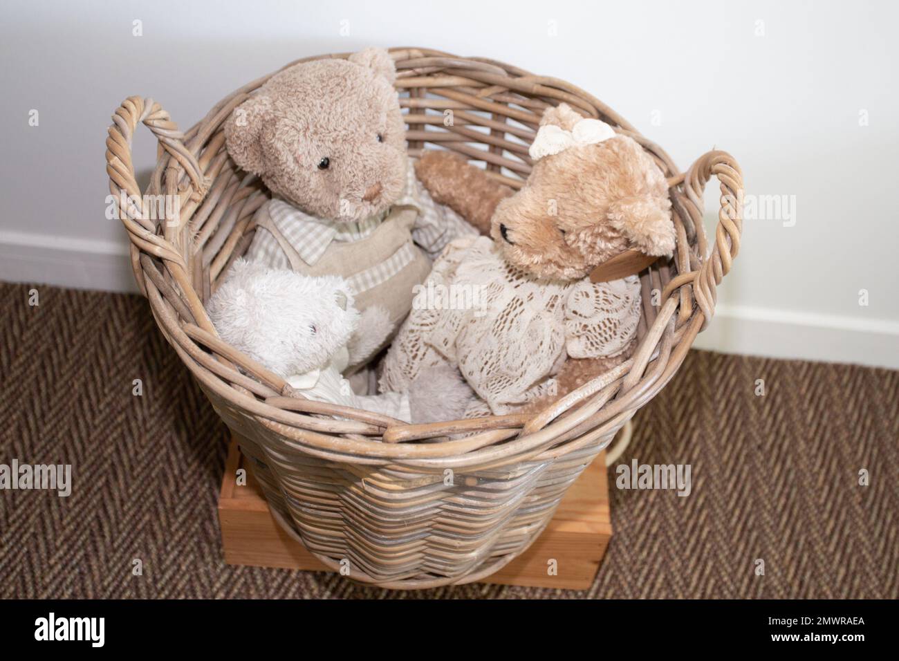 straw basket of stuffed animals vintage teddy bears Stock Photo
