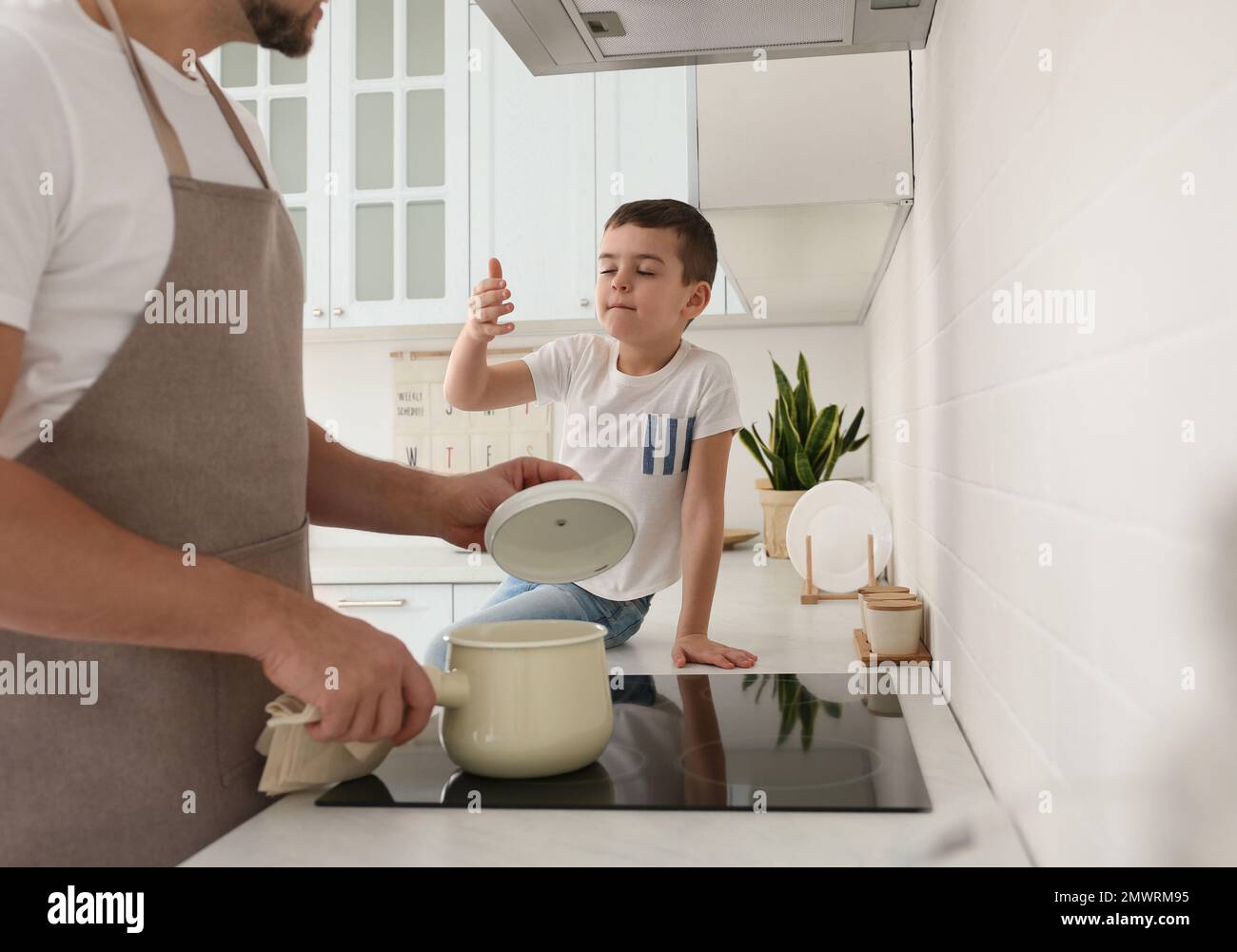 Child smelling food in pot hi-res stock photography and images - Alamy